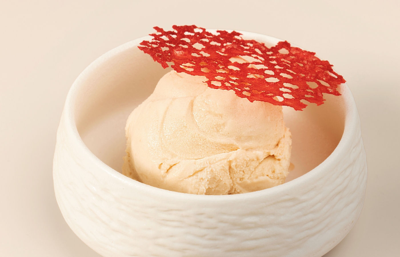 Afrocado gelato scoop with beetroot-dusted meringue shard